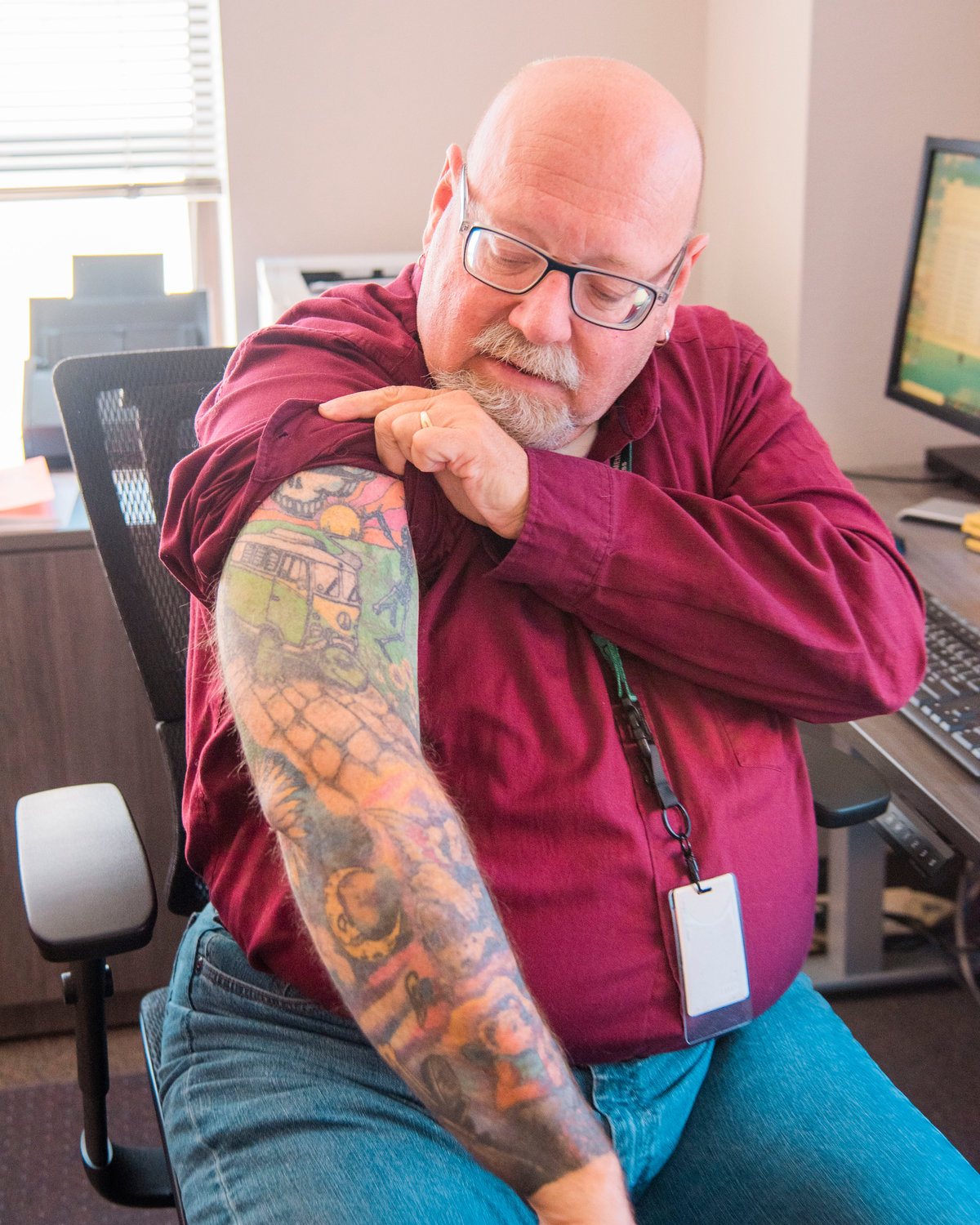 Ross McDowell shows off his Grateful Dead sleeve while sitting in his office Friday at the Lewis County Historic Courthouse in Chehalis.