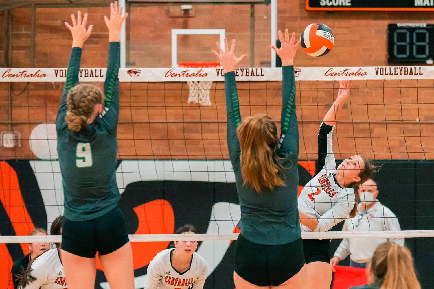 Centralia’s Jadyn Hawley (2) looks to hit the ball past defenders at the net during a volleyball game against Tumwater Tuesday night.