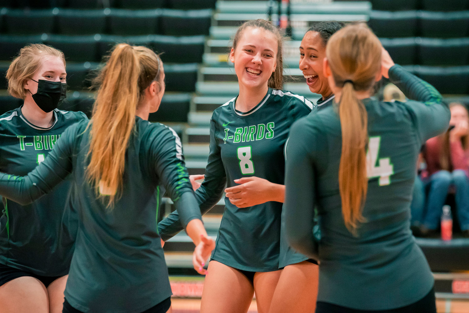 Tumwater athletes smile and celebrate after a score Tuesday night during a volleyball against Centralia.