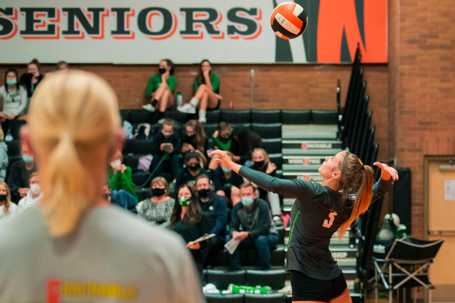 Tumwater’s Emily Robello (3) prepares to serve during a game in Centralia Tuesday night.