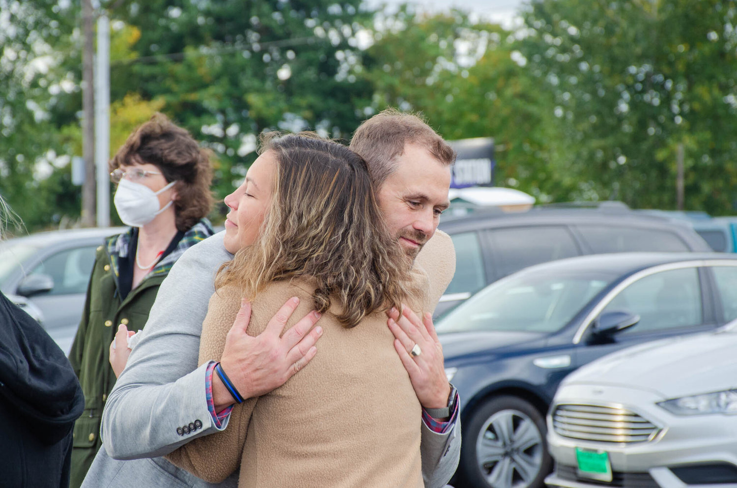 Commissioner Sean Swope receives a hug Thursday morning during a remembrance ceremony at the Mellen Street e-Transit Station for Gary Stamper. “You don’t replace a Gary,” Swope said, “and that’s what’s going to be the most terrible part.”