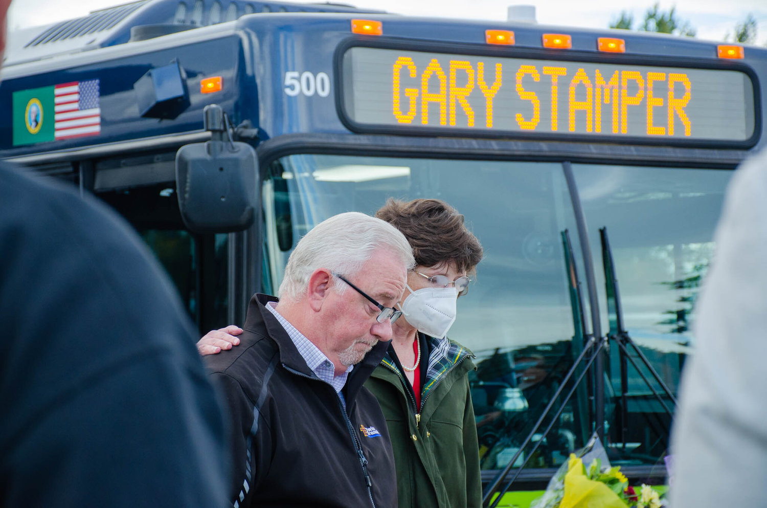 Lewis County Commissioner Lindsey Pollock embraces Twin Transit Executive Director Joe Clark Thursday morning during a remembrance ceremony for Gary Stamper, the senior county commissioner who died Wednesday.