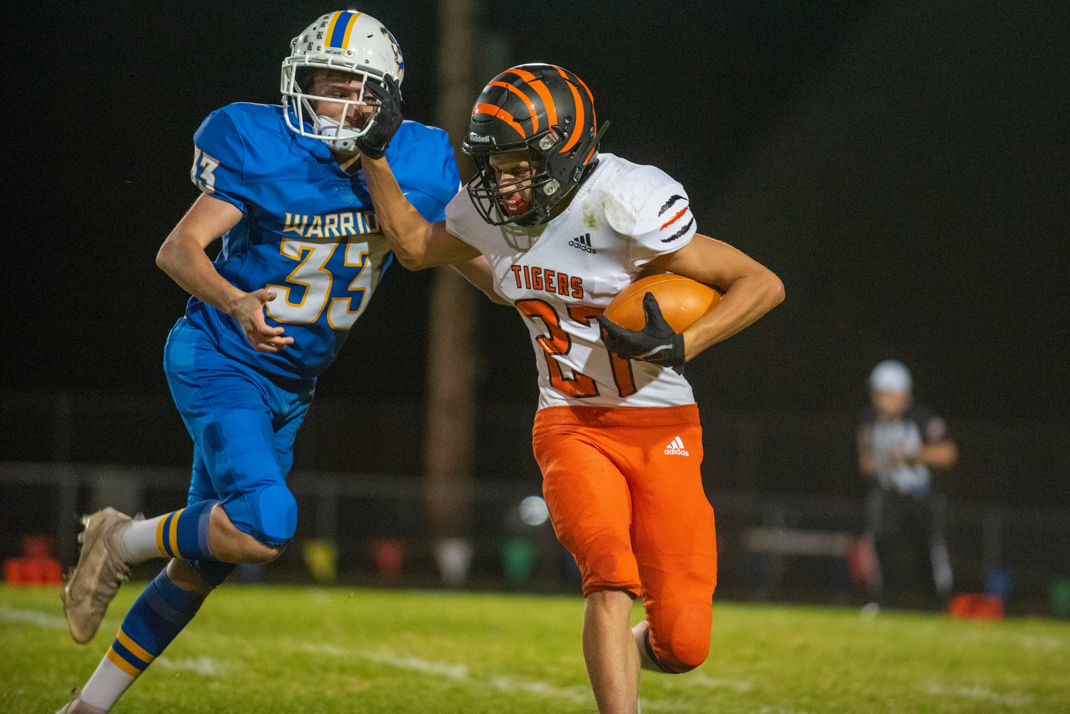 Centralia’s Anthony Saucedo (27) stiff-arms Rochester’s Tristan Nelson (33) on Oct. 2, 2021.