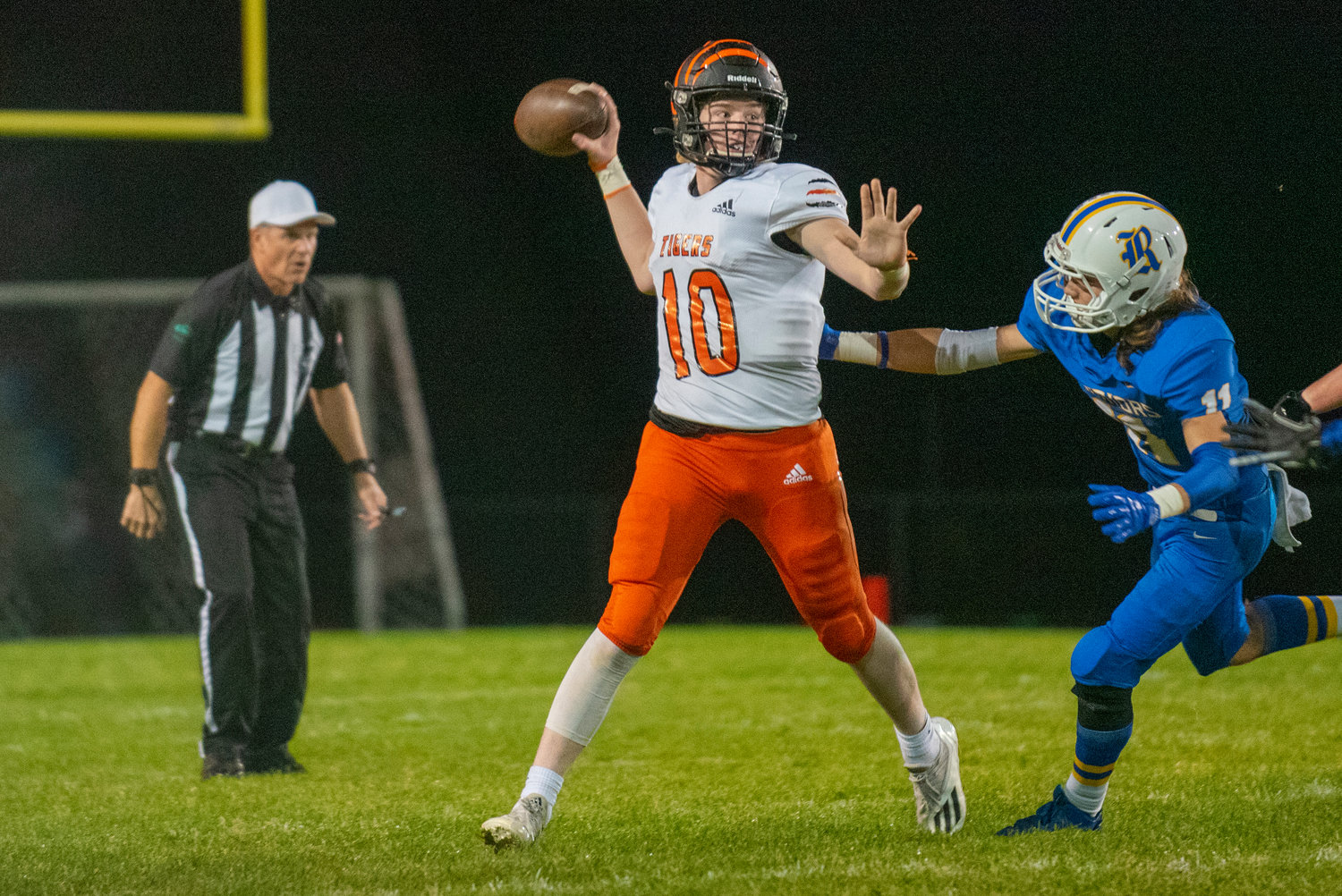 Centralia quarterback Landon Jenkins (10) gets a pass off under pressure from Rochester on Oct. 2, 2021.