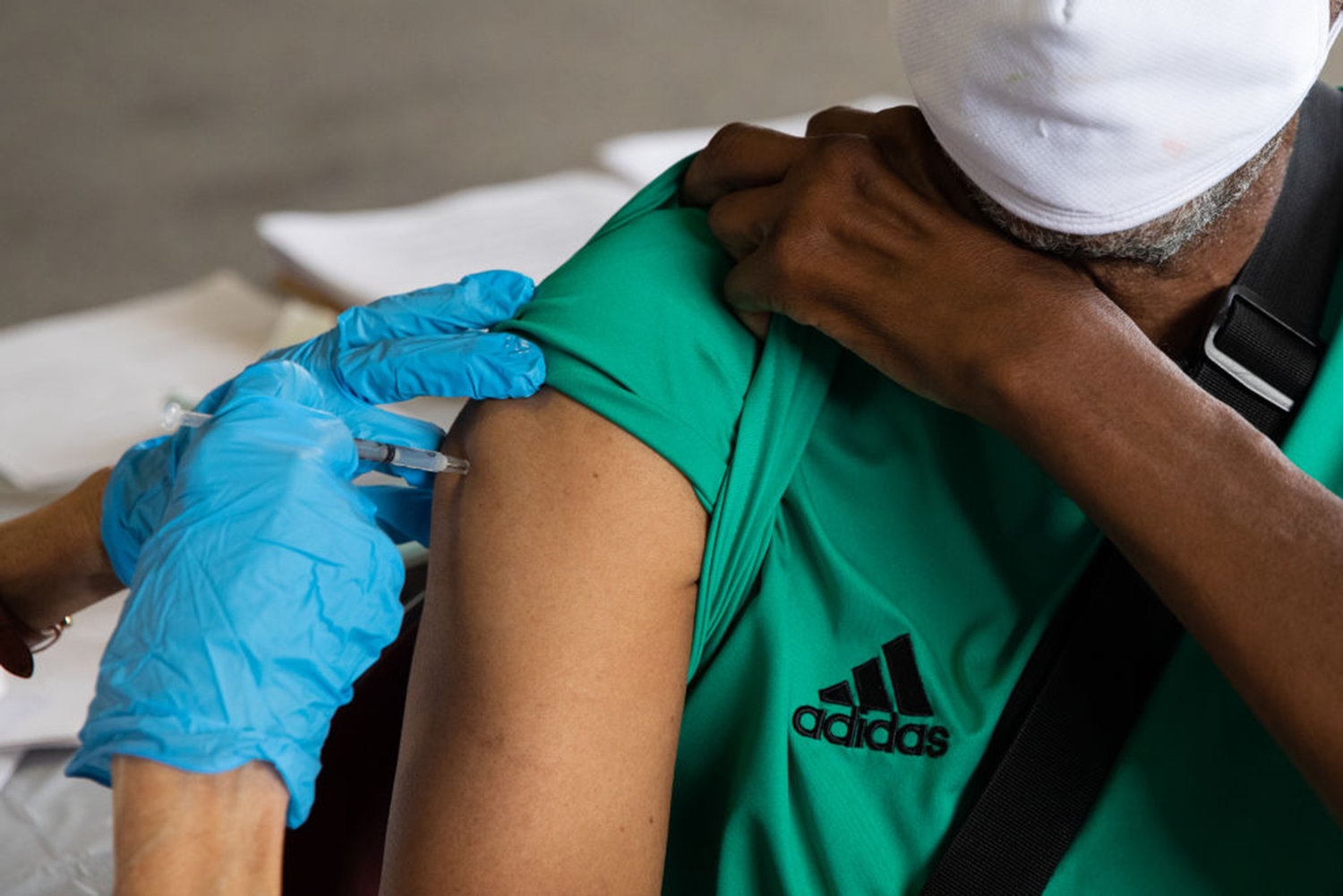 Rufus Peoples receives his booster dose of the Pfizer-BioNTech coronavirus (COVID-19) vaccine during an Oakland County Health Department vaccination clinic at the Southfield Pavilion on Aug. 24, 2021 in Southfield, Michigan. (Emily Elconin/Getty Images/TNS)