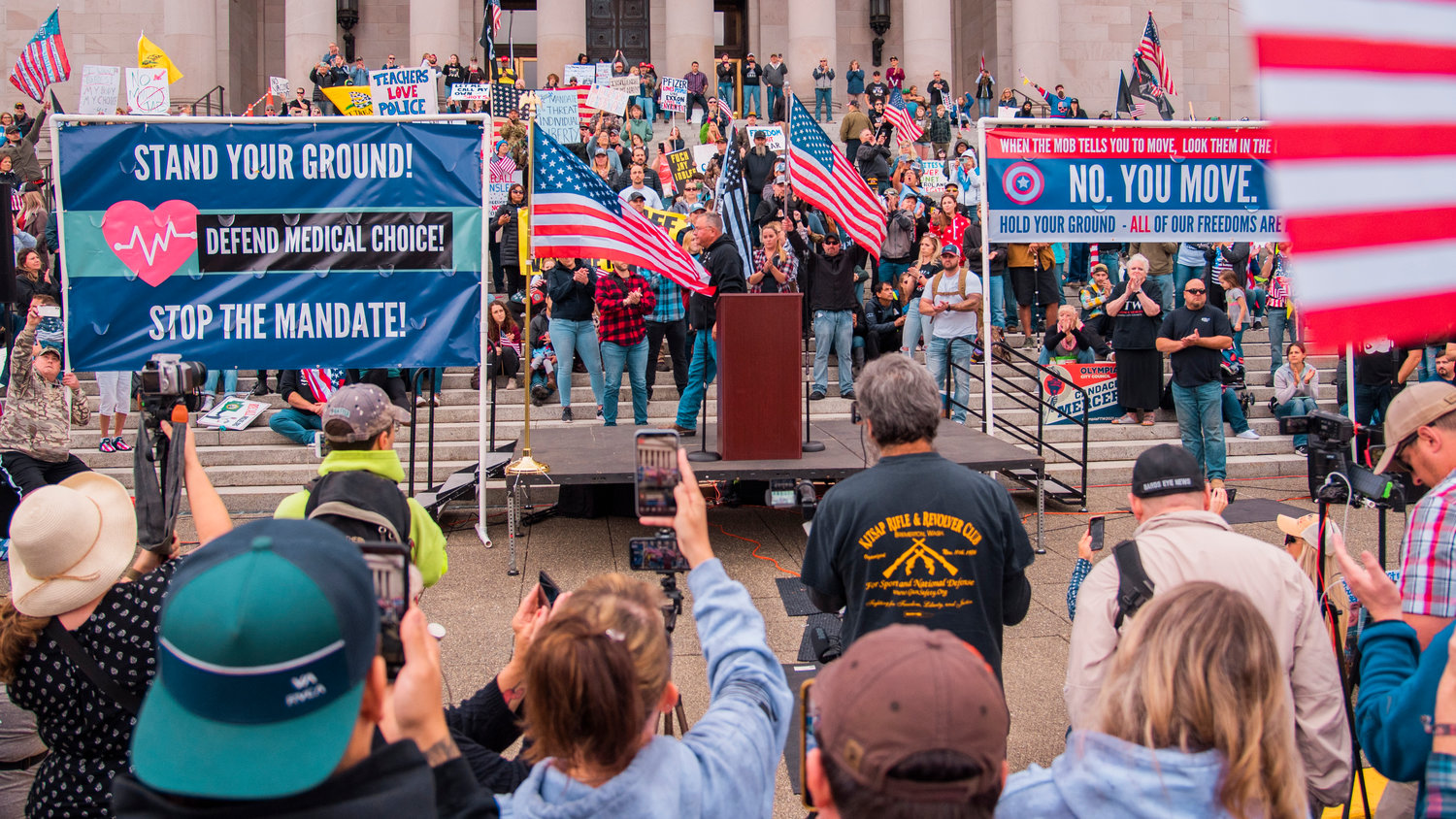 Crowds cheer as Loren Culp takes the stage during a “Medical Freedom Rally” in Olympia on Sunday.