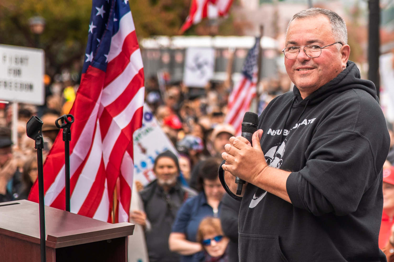Loren Culp smiles while addressing crowds during a “Medical Freedom Rally” in Olympia on Sunday outside the Washington State Capitol Building.