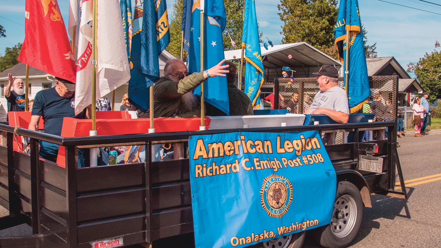 Candy is thrown from the American Legion Richard C. Emigh Post #508 float during the Onalaska Apple Harvest parade Saturday morning.