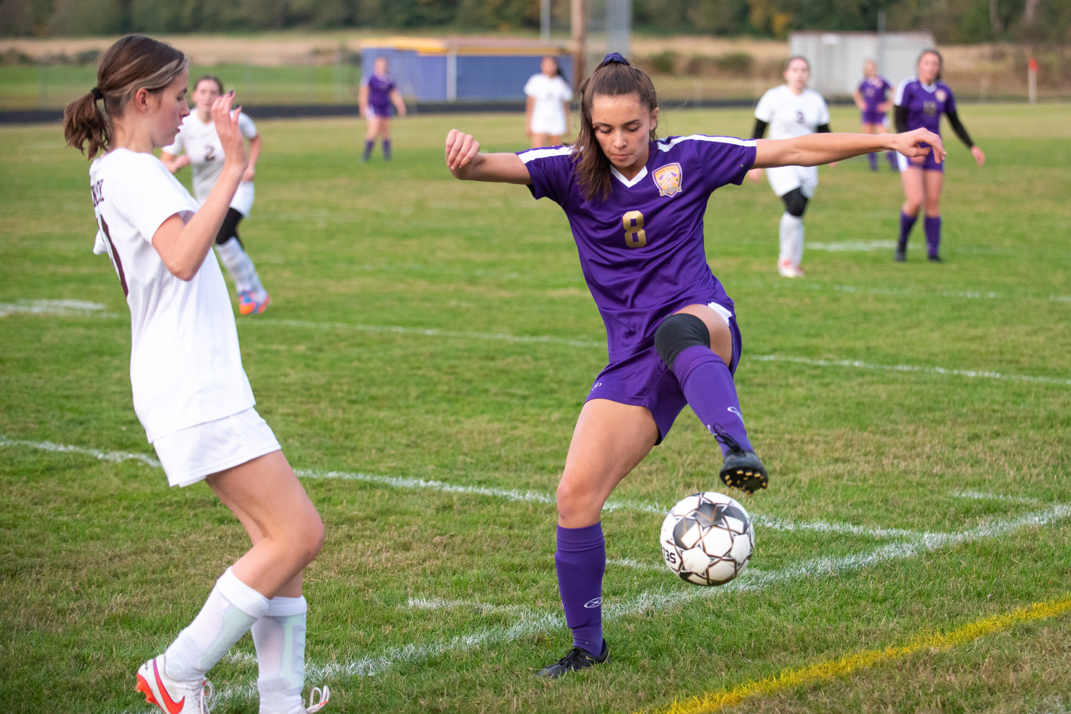 Onalaska junior Brooklyn Sandridge (8) gets control of the ball in front of a Winlock player at home on Monday.