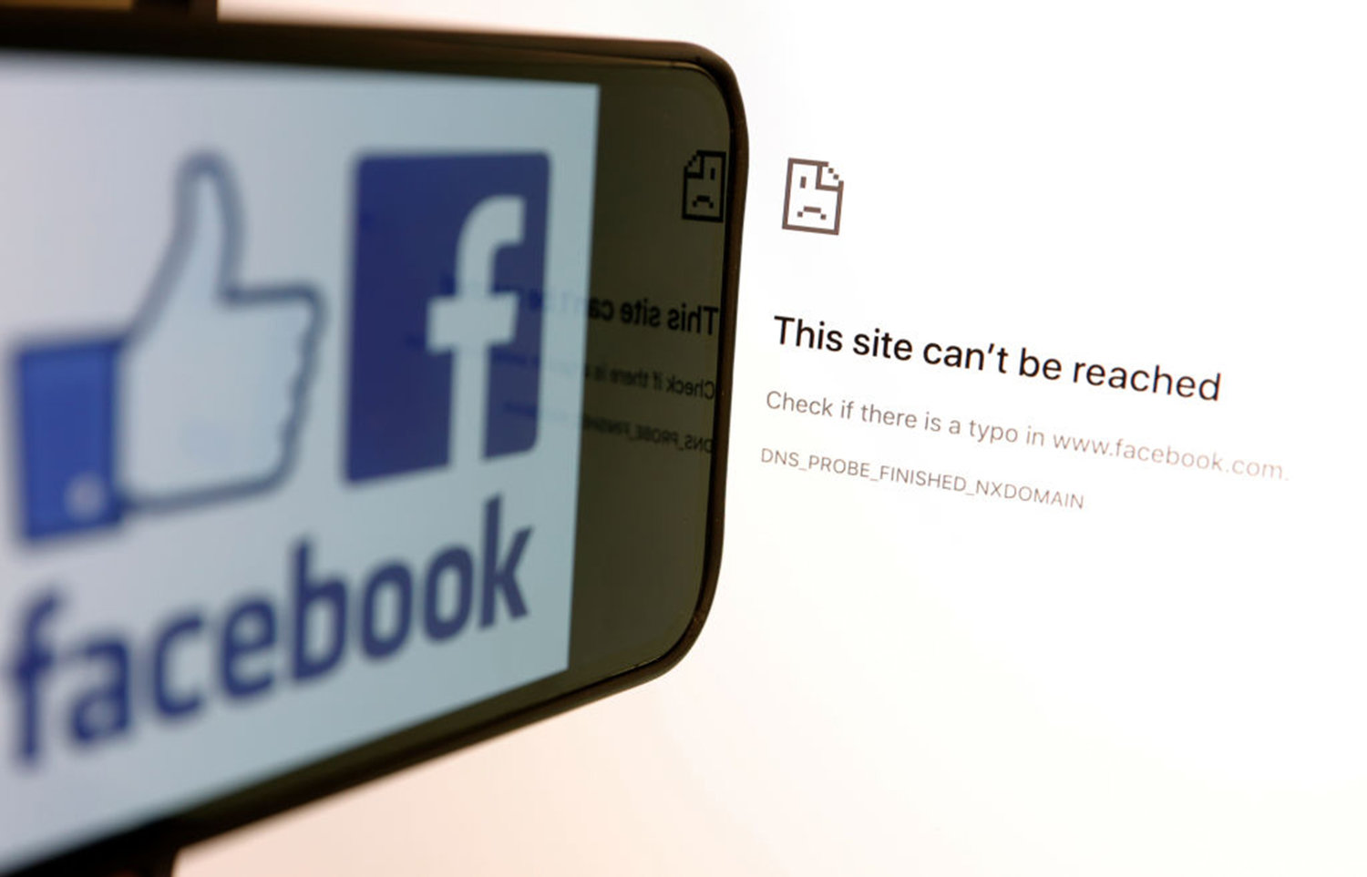 In this photo illustration, the Facebook logo is displayed next to a screen showing that Facbook service is down on Oct. 04, 2021 in San Anselmo, California. Social media applications Facebook, Instagram and WhatsApp are experiencing a global outage that started before 9 a.m. (P.S.T.) on Monday morning. (Justin Sullivan/Getty Images/TNS)