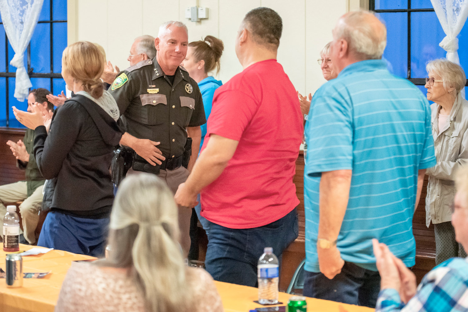 Sheriff Rob Snaza receives a standing ovation after his speech at the Winlock Community Center during a Lewis County Republicans meeting Monday evening.