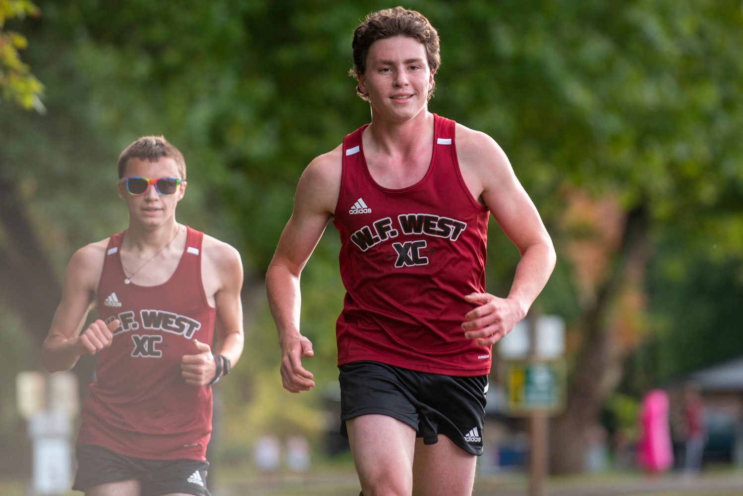 W.F. West's Henry Jordan, right, and teammate Jaysen Miles compete in a three-team meet at Stan Hedwall Park on Wednesday, Oct. 6, 2021.