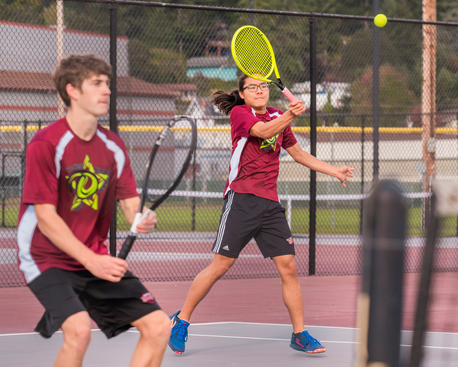 W.F. West’s Joseph Chung returns a ball during a doubles match with Aaron Boggess in Chehalis Wednesday afternoon.