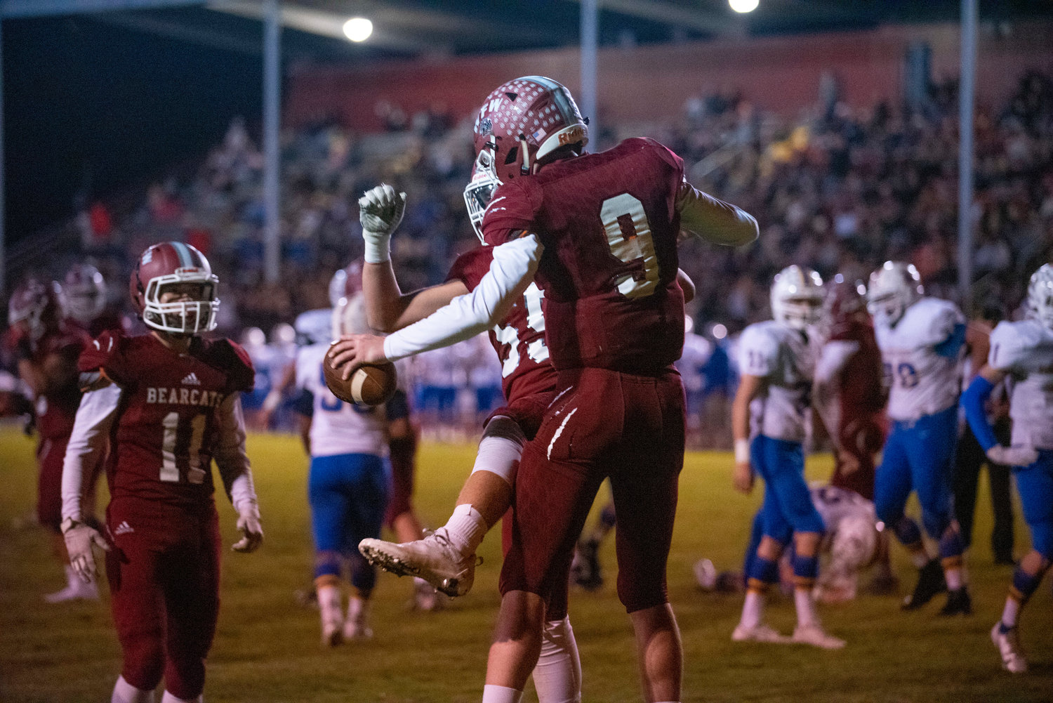W.F. West's Gavin Fugate (9) and Tanner Wallin (59) celebrate Fugate's touchdown run in the second quarter against Rochester on Oct. 8, 2021.