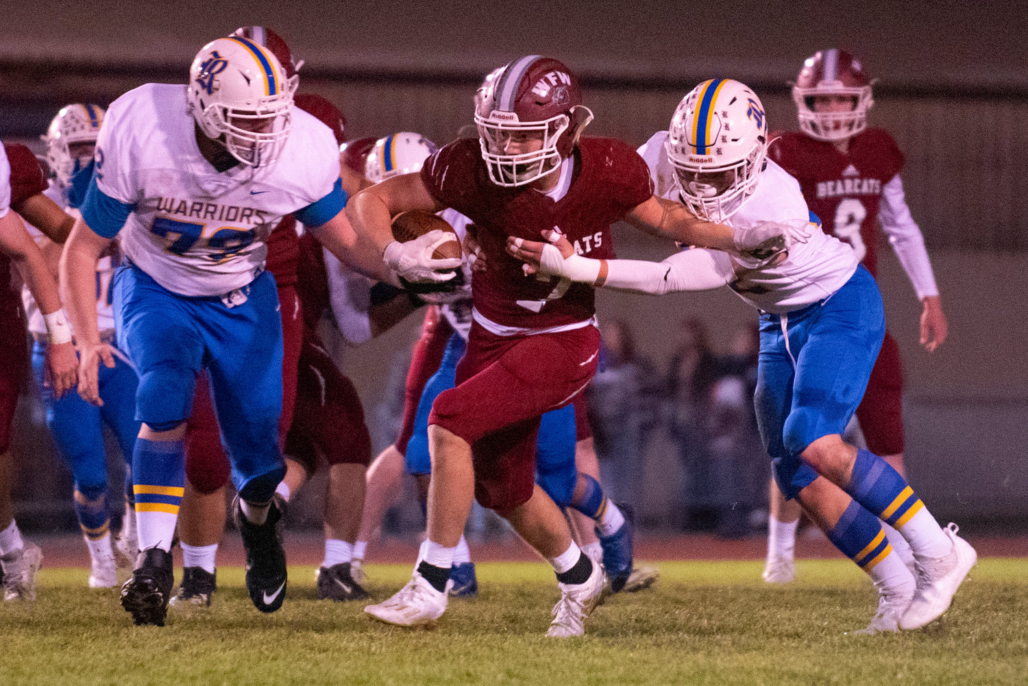 W.F. West running back Brock Guyette (7) tries to escape Rochester's Garren Smith, right, and Hayden Haskins (72) on Oct. 8, 2021.