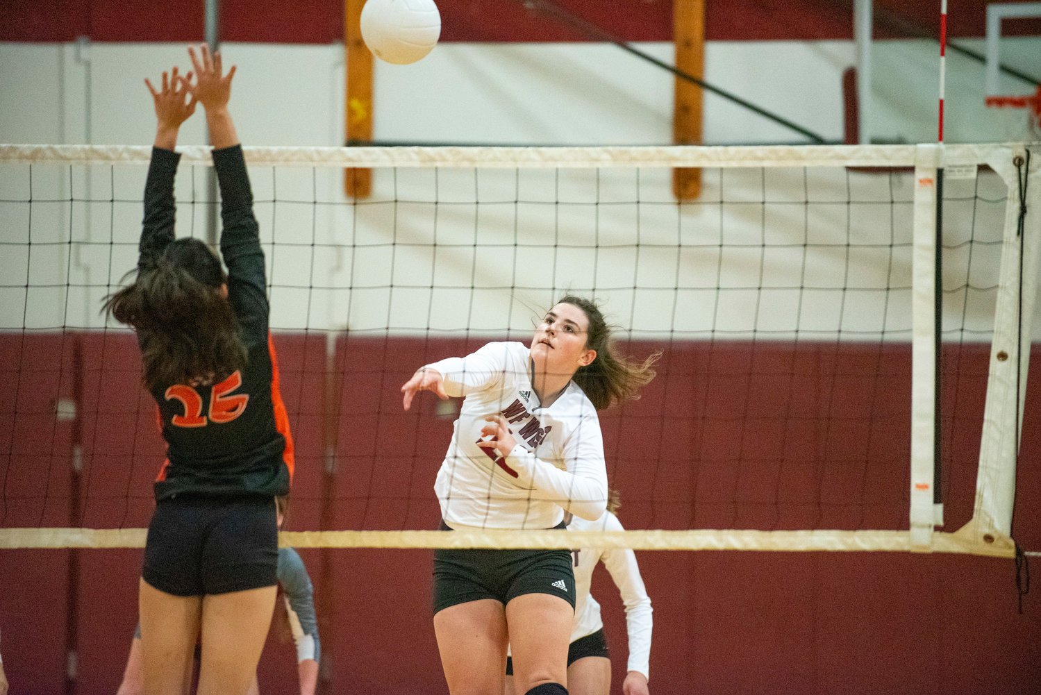 W.F. West's Maggie Busse (12) spikes the ball against Centralia's Peyton Smith (25) on Oct. 12, 2021.