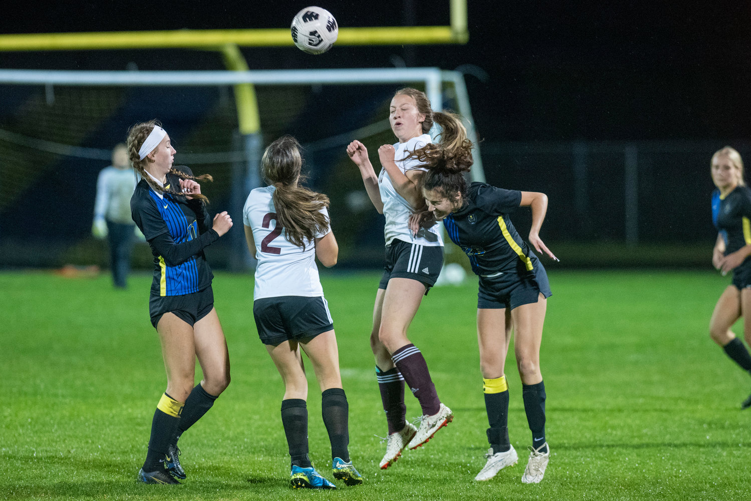 Adna's Presley Smith, right, heads the ball in traffic against Raymond-South Bend on Oct. 13, 2021.