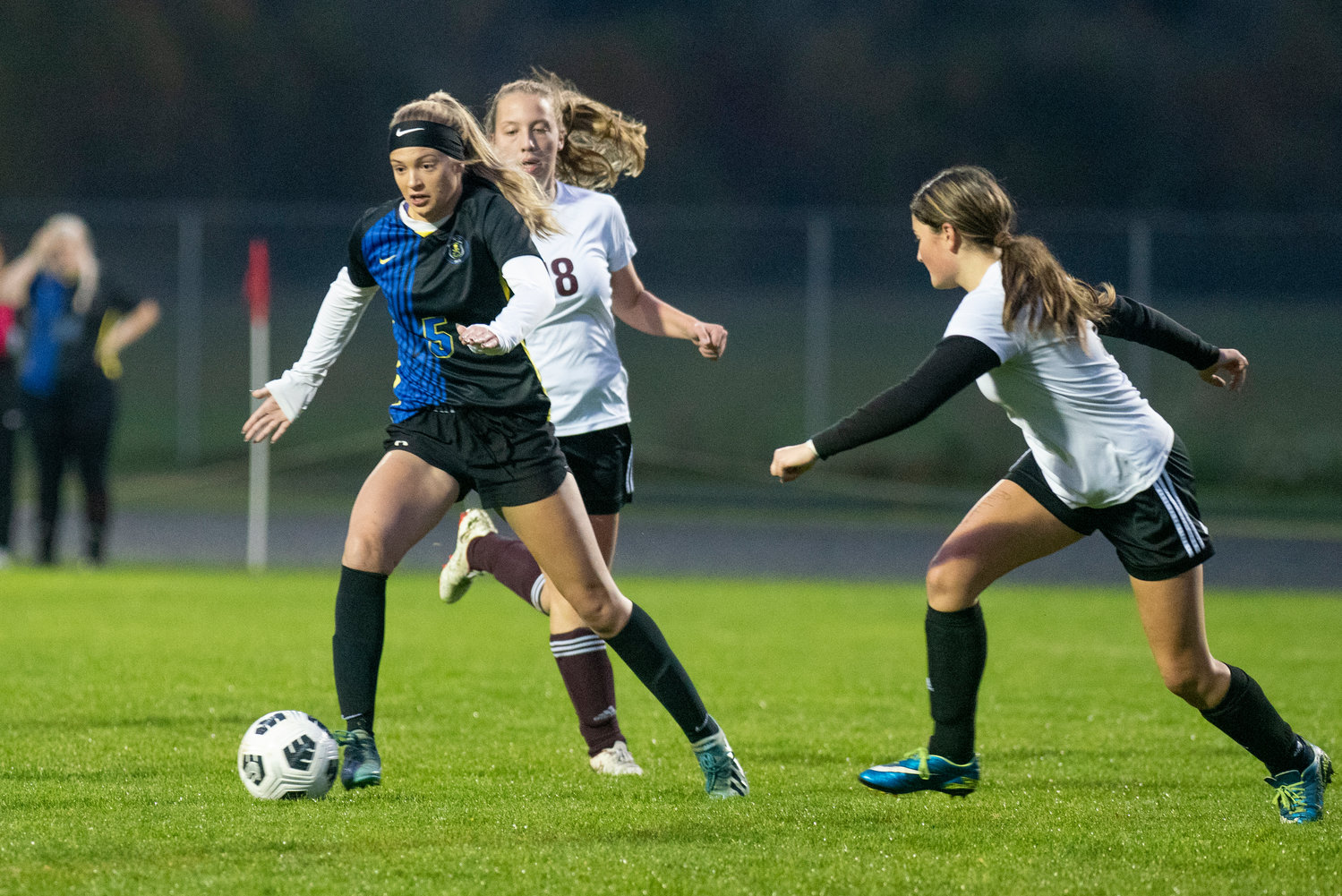Adna's Kaylin Todd (5) gains possession against two Raymond-South Bend players on Oct. 13, 2021.