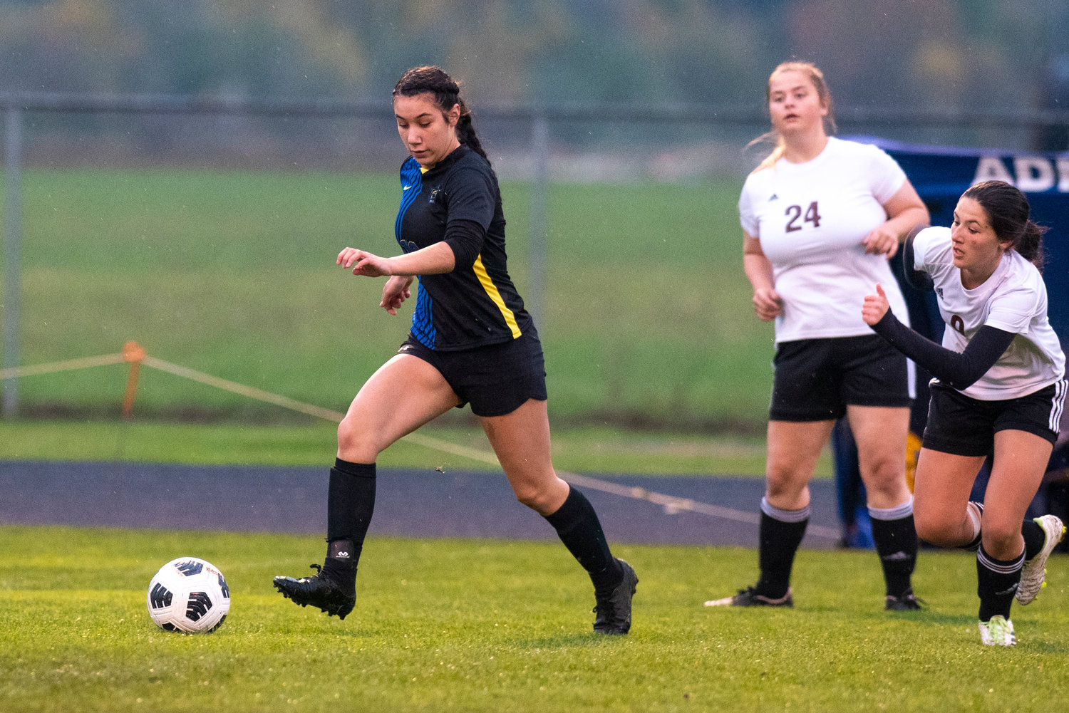 Adna's Zarine Walker (16) gains possession against two Raymond-South Bend players during a match on Oct. 13, 2021.