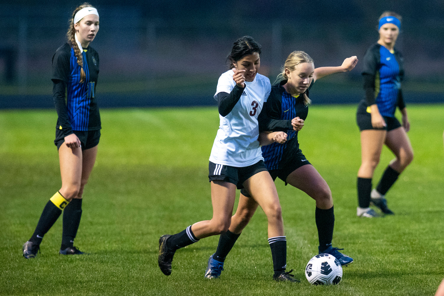 Adna's Lilly Wellander (12) battles with a Raymond-South Bend player for possession on Oct. 13, 2021.