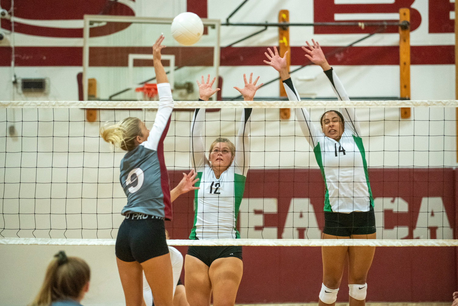 W.F. West's Ava Olsen (9) spikes against Tumwater's Madison Hurley (12) and Isabella Burney (14) on Oct. 14, 2021.