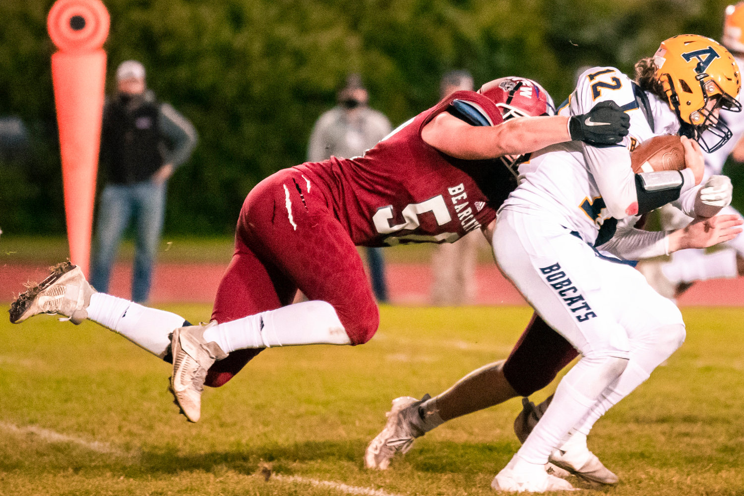 Aberdeen’s Jakob Bowers (12)is brought down by W.F. West’s William Buzzard (50) Friday night during a game against W.F. West.