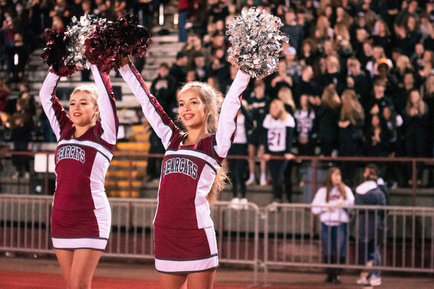 Cheerleaders raise their pom-poms during a game Friday night in Chehalis.