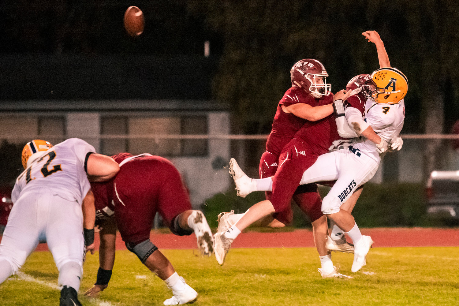 Bearcat defenders put a hit on Aberdeen’s Quarterback Kale Goings (4) as he throws the football incomplete Friday night in Chehalis.