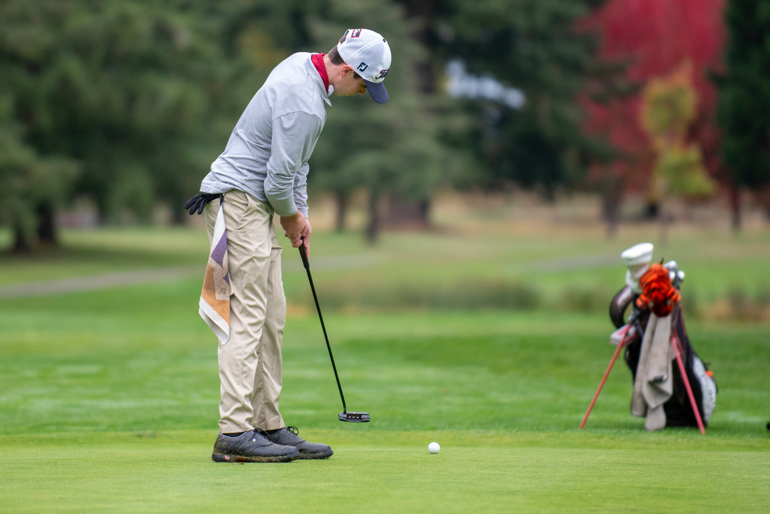 W.F. West freshman Ben Halverstadt putts on the final hole during the 2A Evergreen Conference championships on Oct, 18, 2021, at Riverside Golf Course.