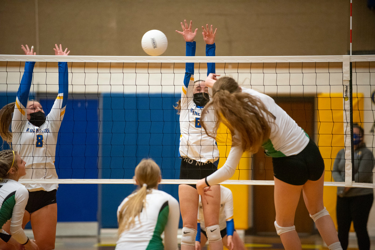 Tumwater's Alyssa Duncan (1) spikes against Rochester's Hailey Angwood (8) and Lauren Rotter (6) during a match in Rochester on Oct. 19, 2021.