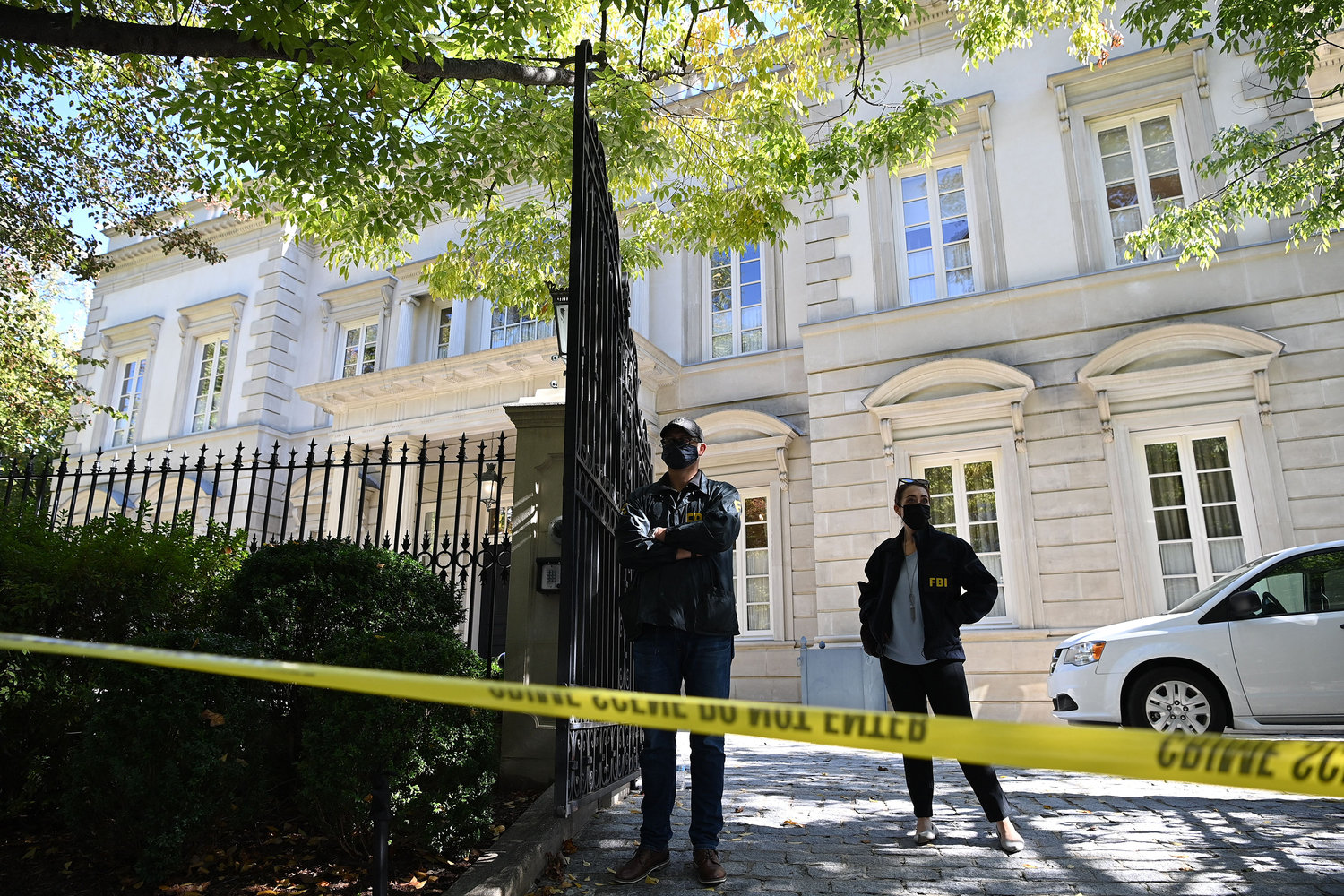 FBI agents stand guard outside the home of Russian oligarch Oleg Deripaska in Washington, D.C., on Oct. 19, 2021. FBI agents were conducting a search of the home, conducting "court-authorized law enforcement activity" at the home in a fashionable district of the U.S. capital. (Mandel Ngan/AFP/Getty Images/TNS)