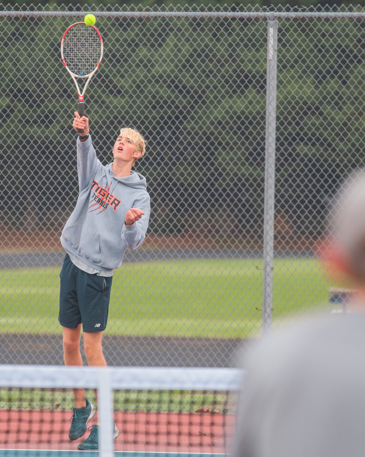 Centralia’s Jacoby Corwin serves up a shot during a doubles match at Black Hills High School Tuesday afternoon.