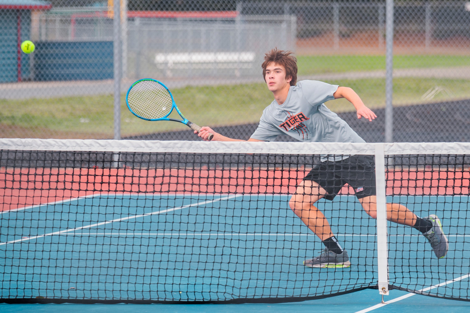 Centralia’s Brandon Yeung tracks a ball over the net during a doubles match at Black Hills High School Tuesday afternoon.