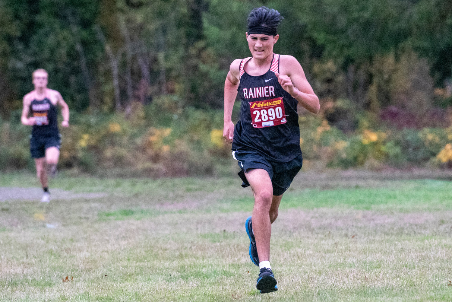Rainier senior Dylan Davis sprints toward the finish line to claim first place at the 2B Central League boys cross country championships in Onalaska on Thursday, Oct. 21, 2021.