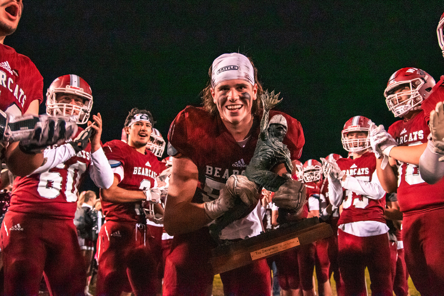 W.F. West’s Tanner Wallin (59) smiles while holding the Swamp Cup trophy after a home victory over Centralia Friday night.