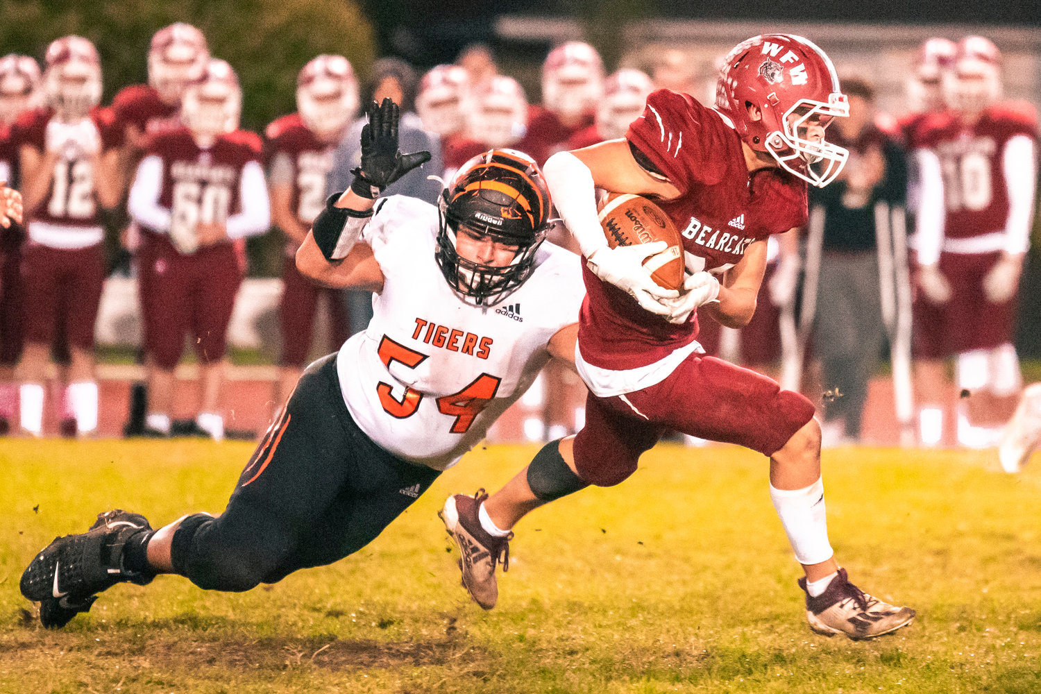 Centralia’s Isaiah Vasquez (54) dives for W.F. West’s Evan Stajduhar (23) as he runs by with the football Friday night during the Swamp Cup rivalry match at Bearcat Stadium.