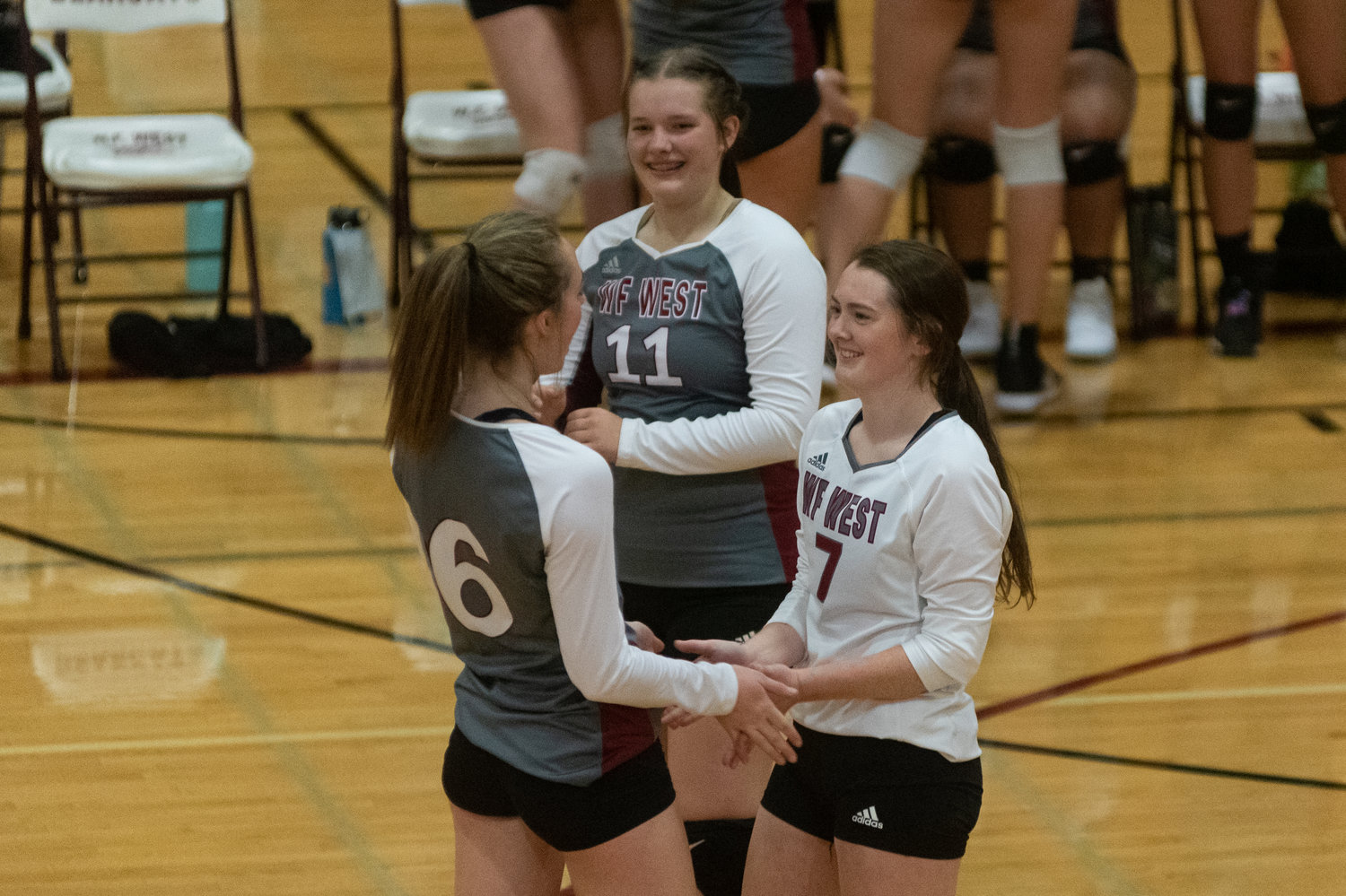 FILE PHOTO -- W.F. West volleyball players Kambriah Simper (7), Morgan Rogerson (6), and Savannah Hawkins (11) celebrate a point against Aberdeen Oct. 26.
