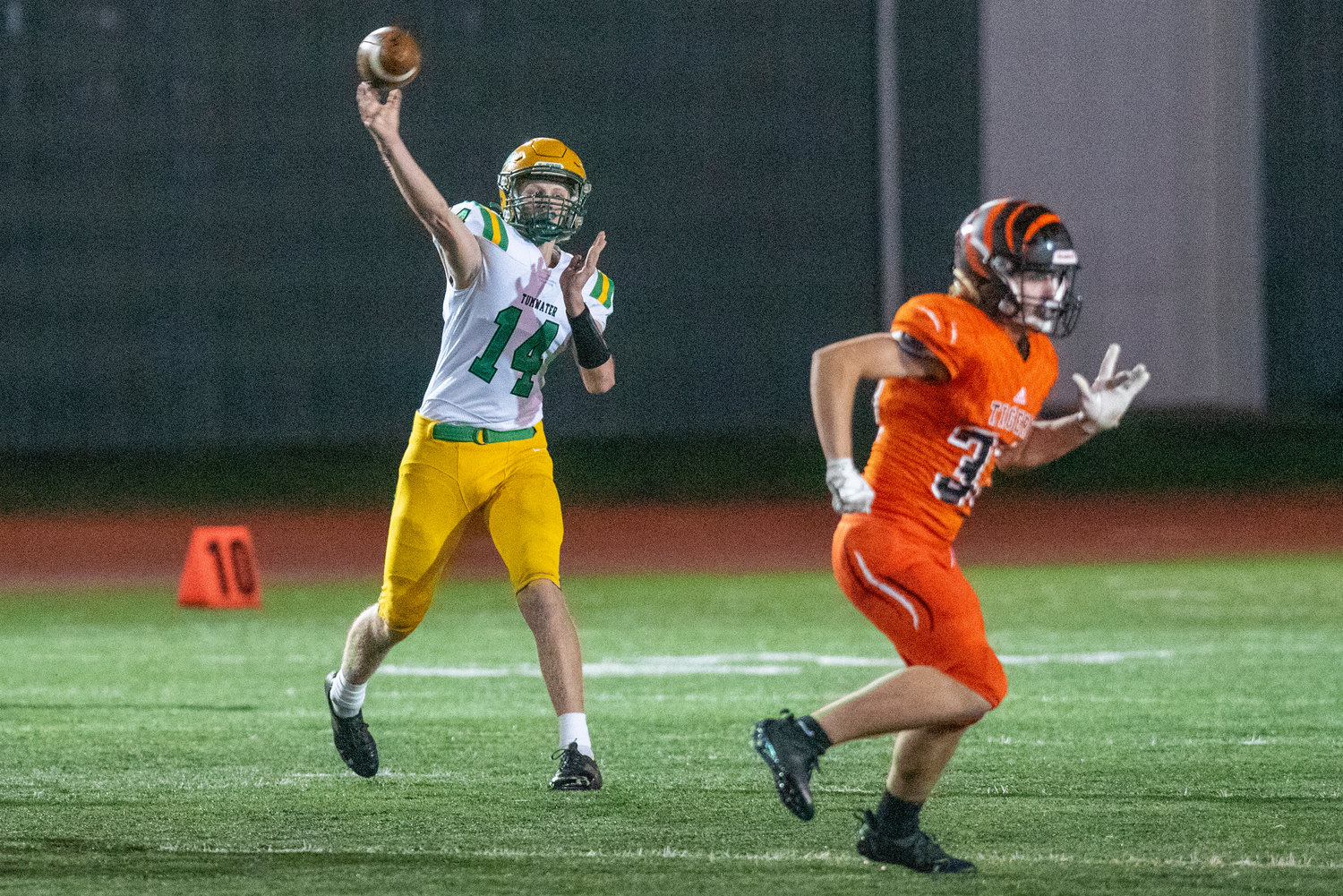 Tumwater quarterback Alex Overbay (14) fires a pass against Centralia at Tiger Stadium Oct. 29.