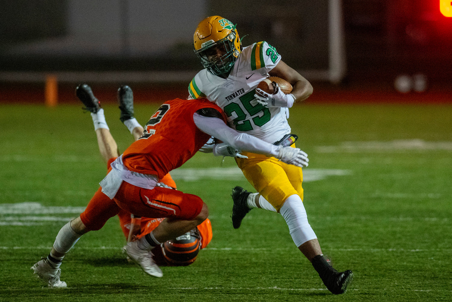 Centralia free safety Chase Sobolesky (2) wraps up Tumwater running back Carlos Matheney (25) during a game at Tiger Stadium Oct. 29.
