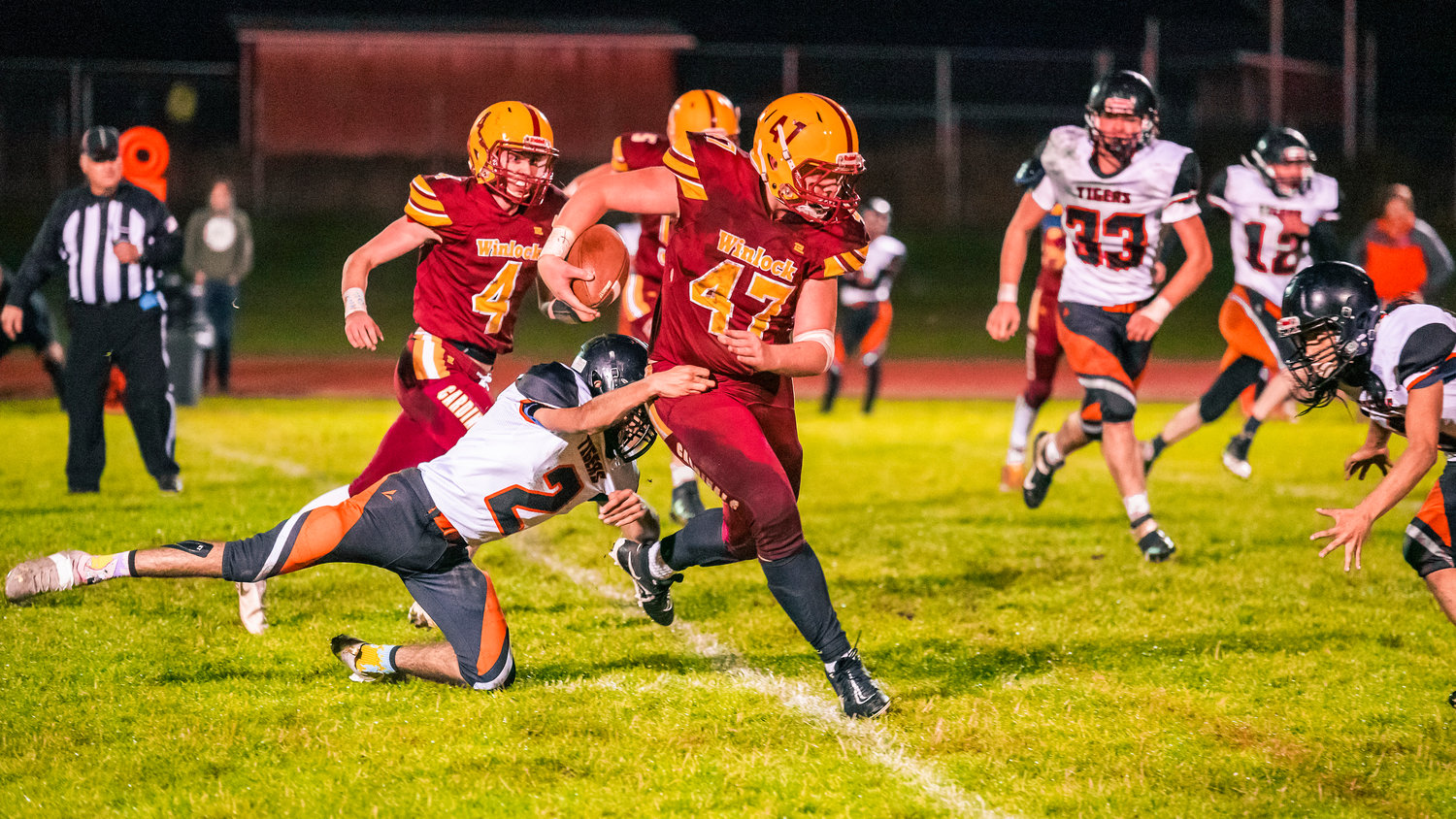Winlock Senior Nolan Swofford (47) breaks a tackle as he runs with the football Friday on Homecoming night.
