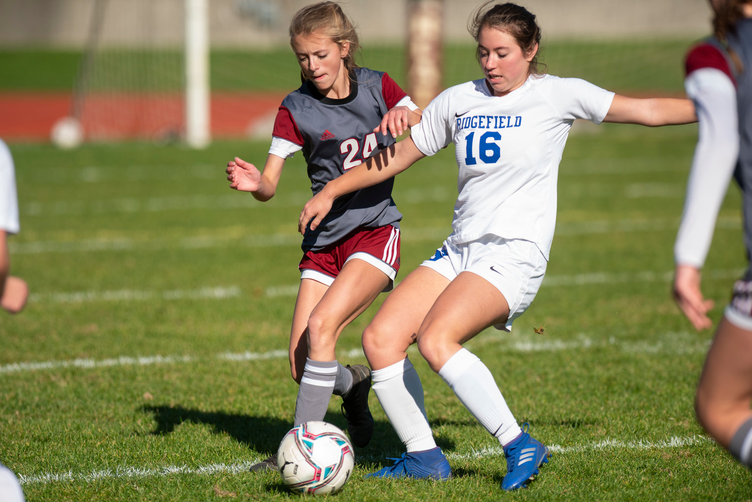 W.F. West defender Brielle Etter (24) battles for possession with Ridgefield's Kellie Krsul (16) during district play on Saturday in Chehalis.