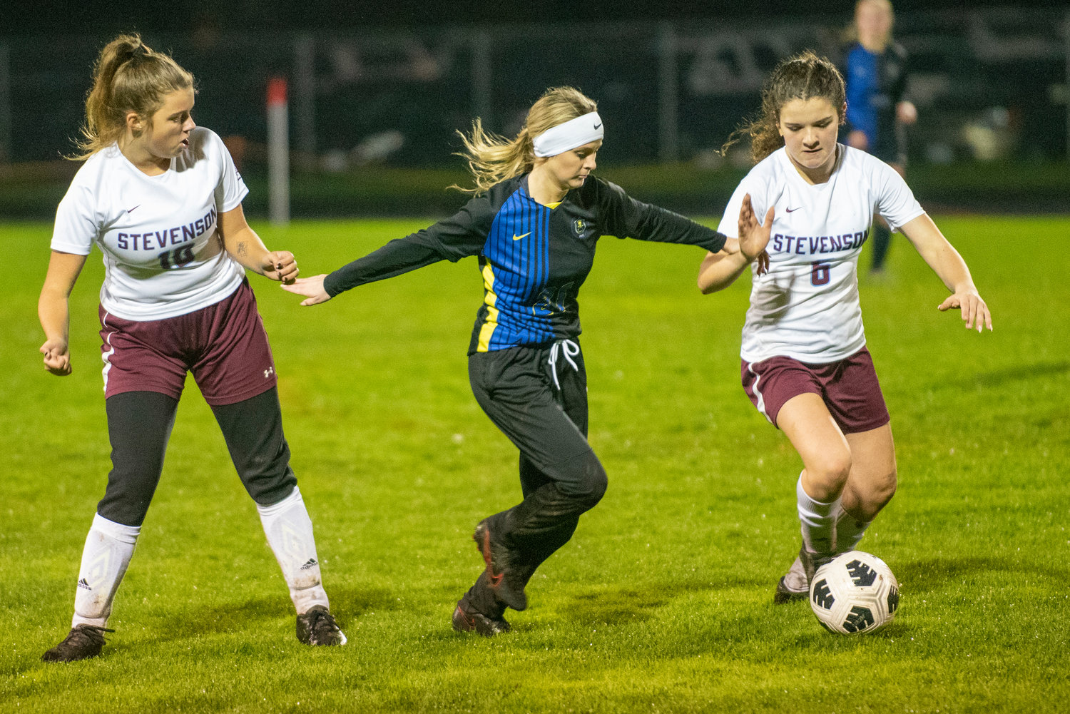 Adna's Natalee Werner (21) fights off two Stevenson players in the district playoffs at home Nov. 1.