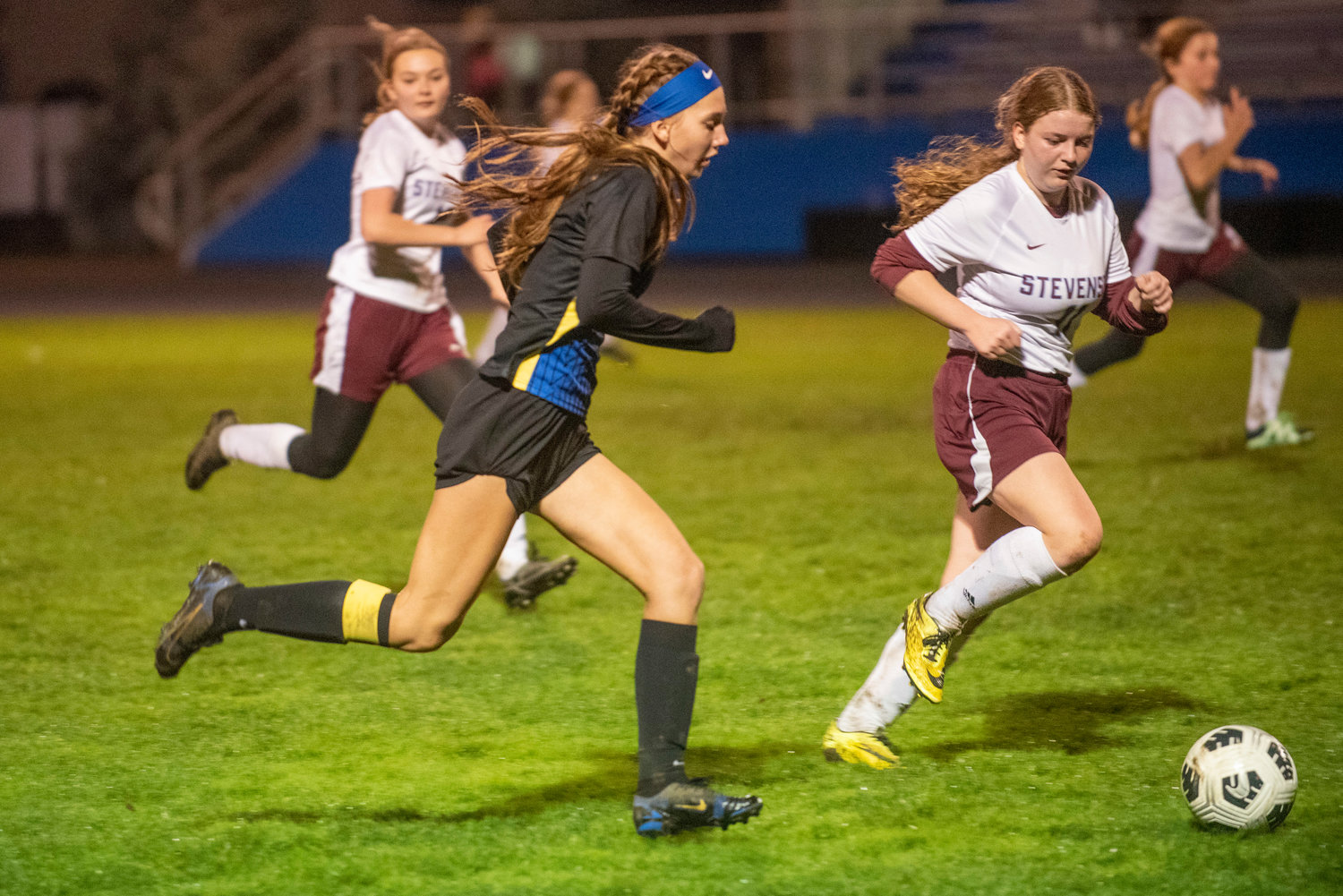 Adna's Faith Wellander races with the ball past Stevenson players during the district playoffs at home Nov. 1.