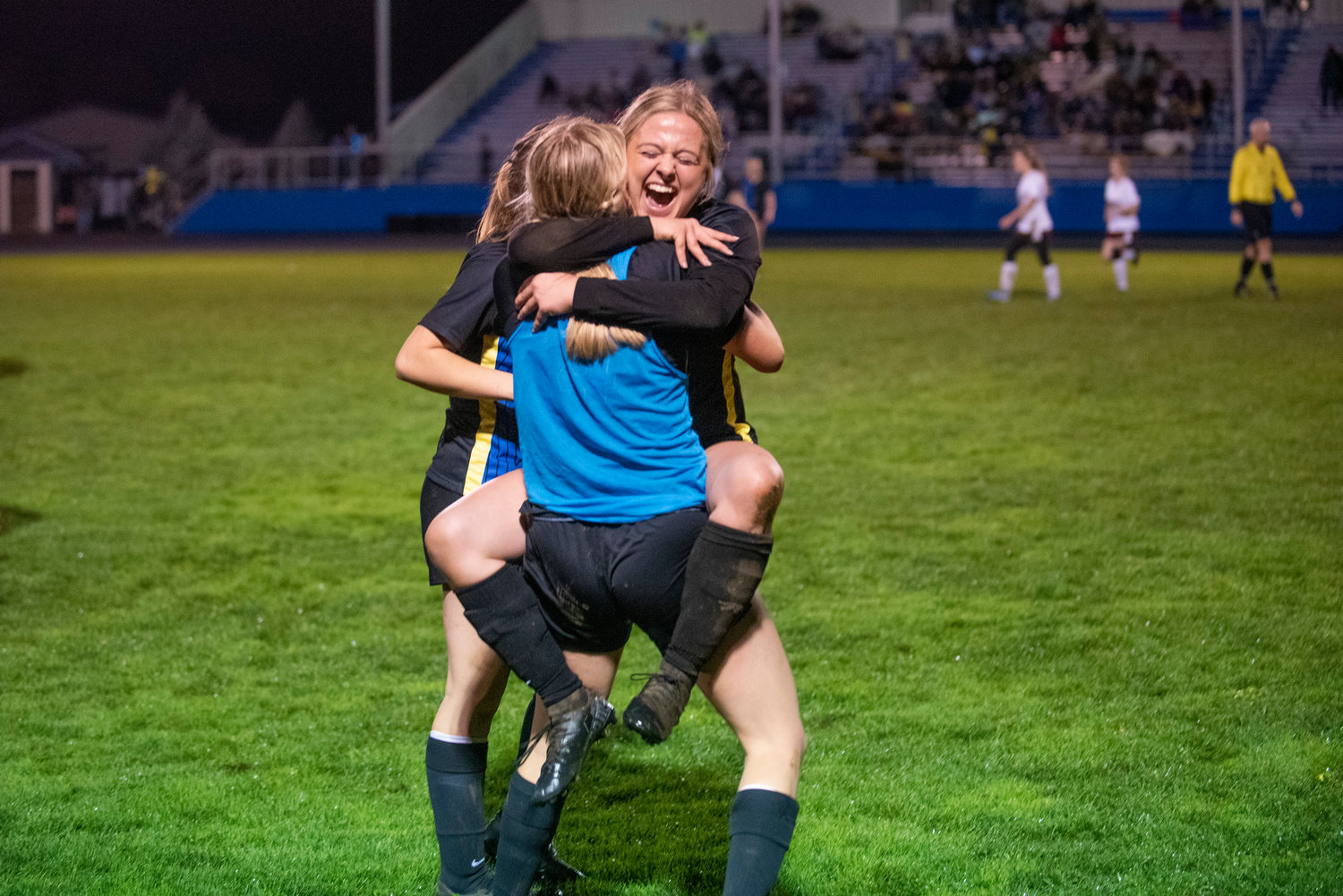 Adna senior Macy Kalnoski jumps into Lydia Tobin's arms after the Pirates defeat Stevenson, 7-0, in the opening round of districts Monday at home to secure a state playoff berth .