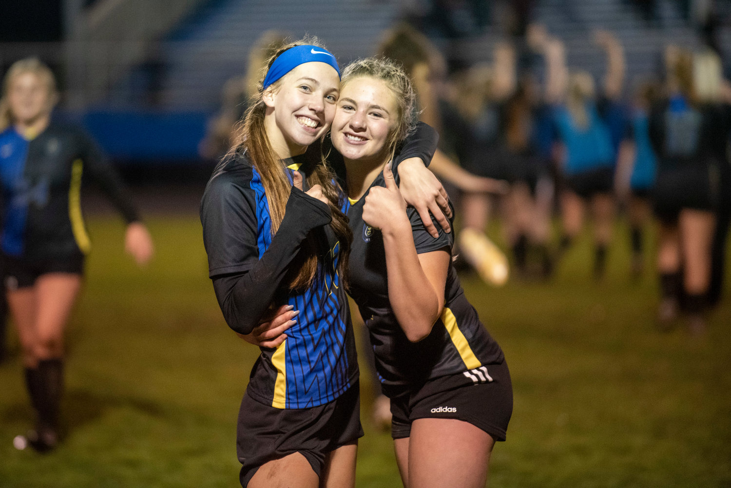 Faith Wellander, left, and Summer White pose for a photo after defeating Stevenson in the district playoffs Nov. 1.