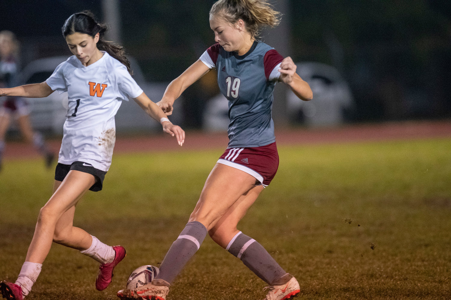 W.F. West's Kyla McCallum (19) fights for the ball against Washougal's Jamie Maas (1) during a district playoff match at home on Tuesday, Nov. 2.