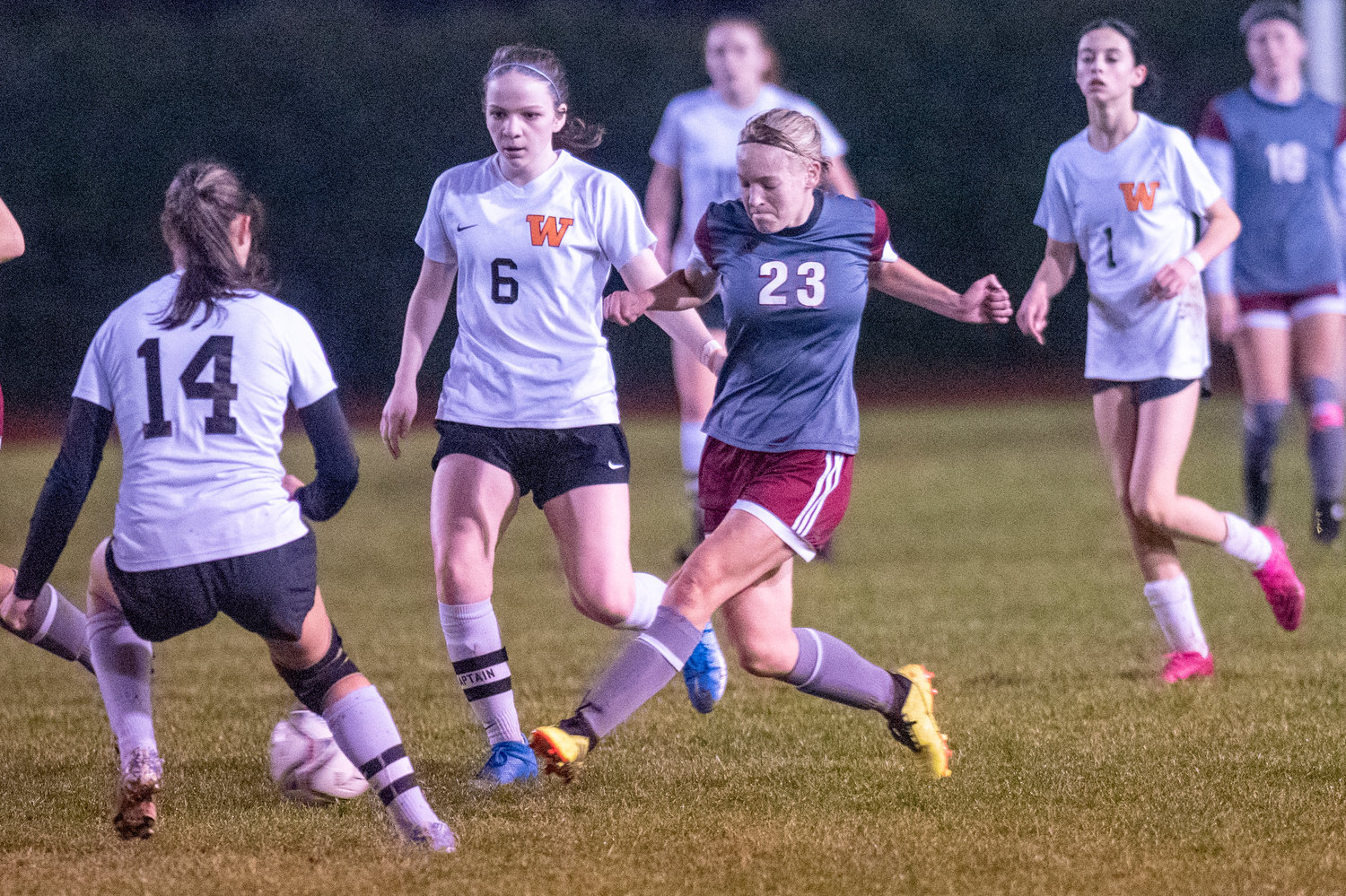 W.F. West's Jocelyn Robertson (23) battles for possession against Washougal in a district playoff match at home Tuesday. Nov. 2