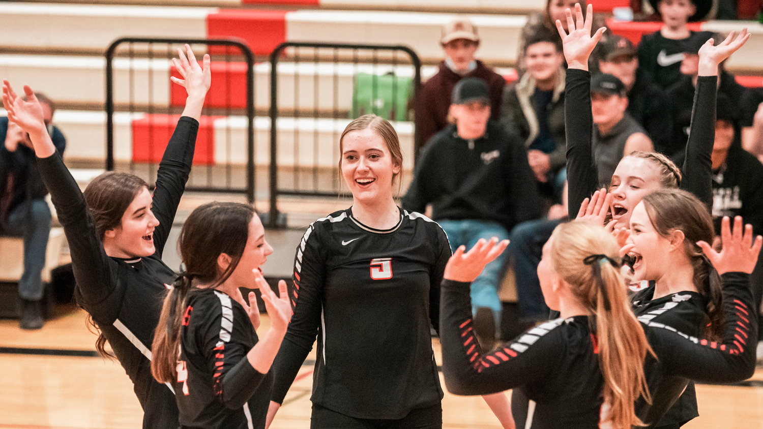 Mossyrock Senior Jolee Hadaller (5) smiles as Vikings celebrate a score Tuesday night during a District 4 1B Volleyball Tournament matchup against Oakville.