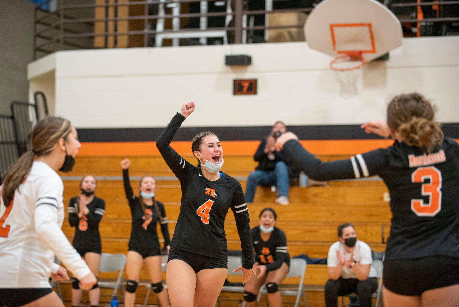 Rainier's Natasha Wood (4) yells in celebration after the Mountaineers score a point against Forks in the district playoffs Wednesday.