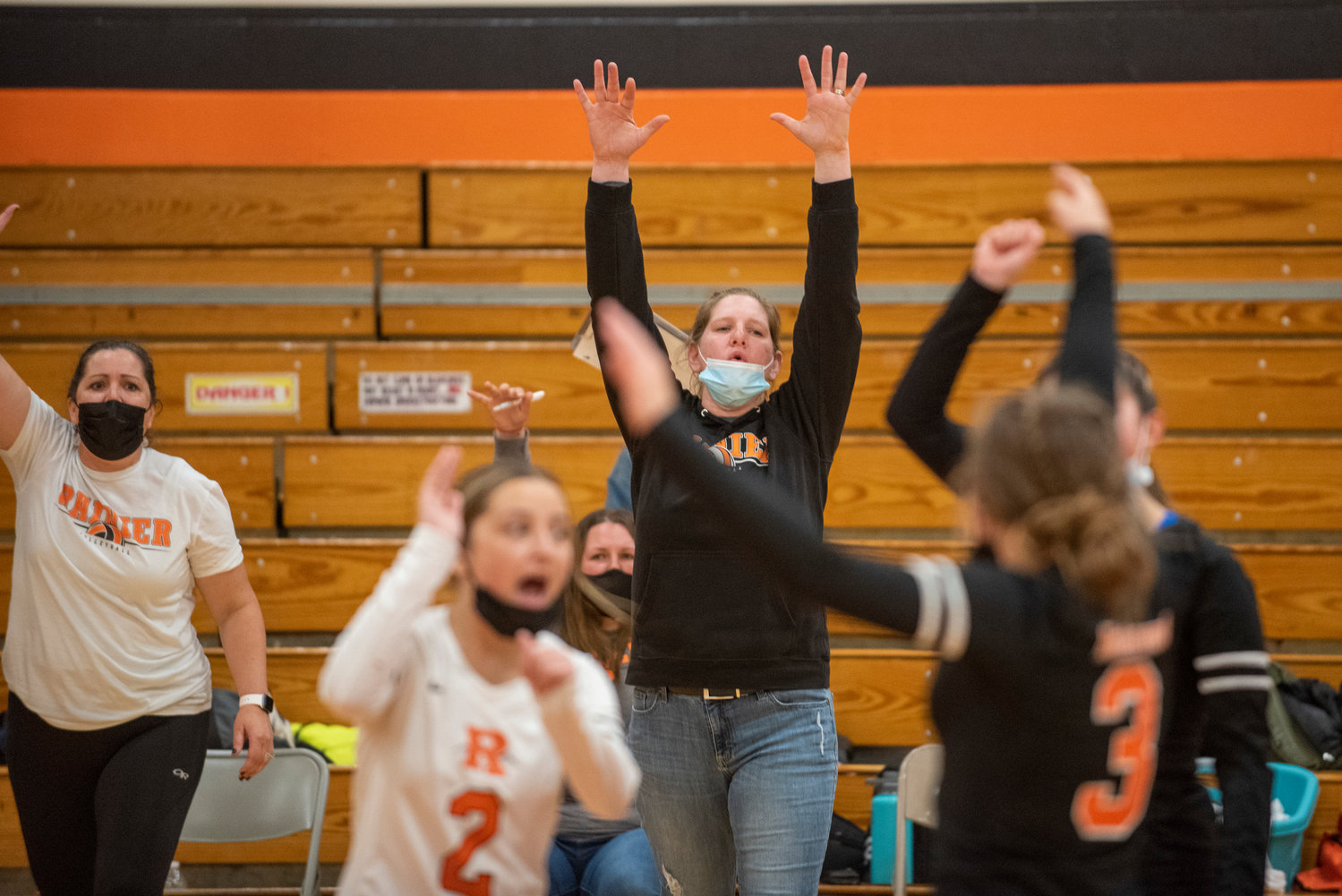 Rainier coach Shauna Carpenter raises her hand in celebration during a state-clinching victory over Forks on Wednesday.